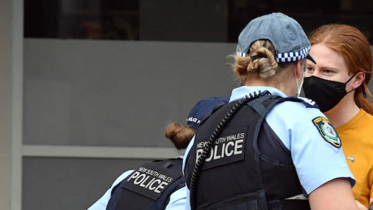 NSW police check identifications at George St in front of the Sydney Town Hall in anticipation of an anti-lockdown rally in Sydney Sydney, Saturday, July 31, 2021. (AAP Image/Mick Tsikas) NO ARCHIVING