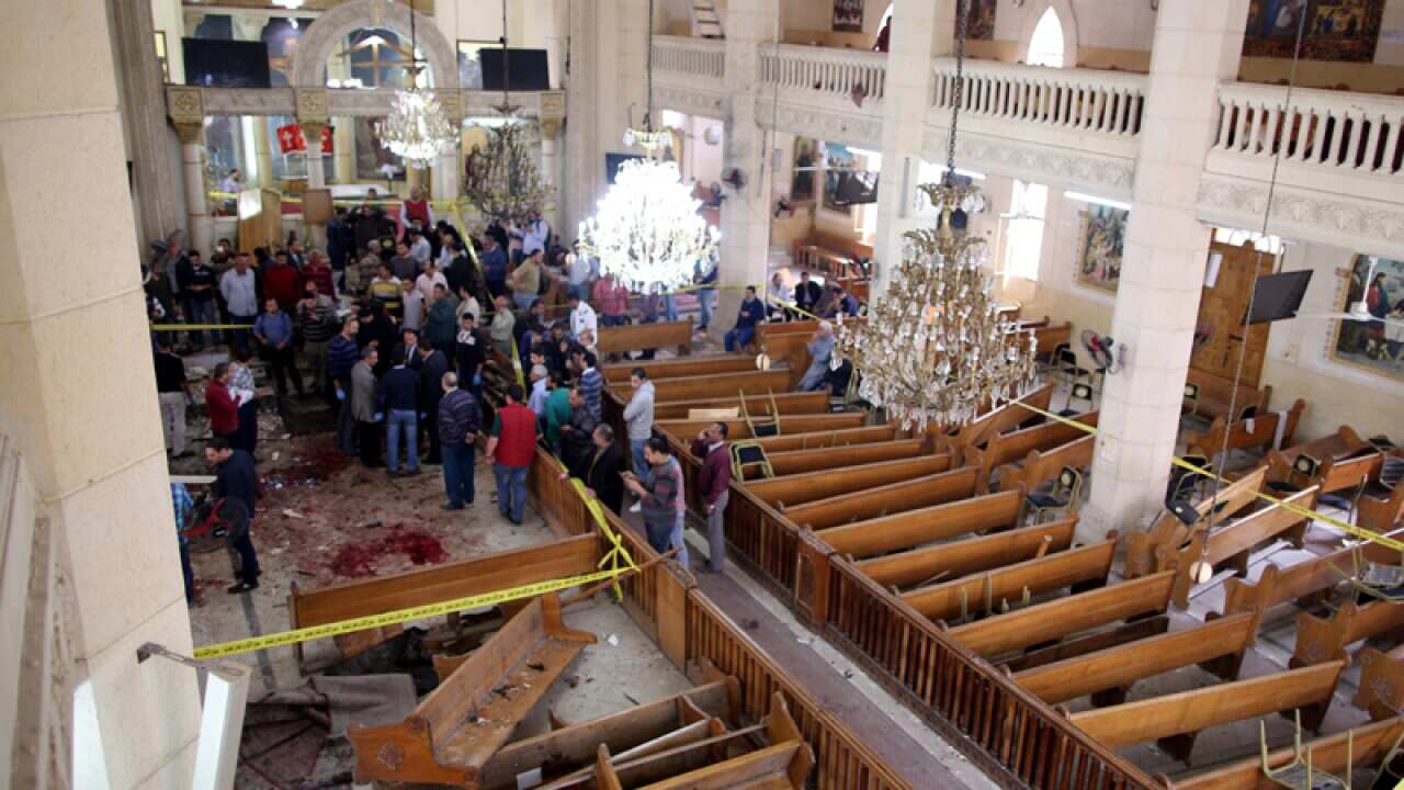 Security personnel investigate the scene of a bomb explosion in Tanta