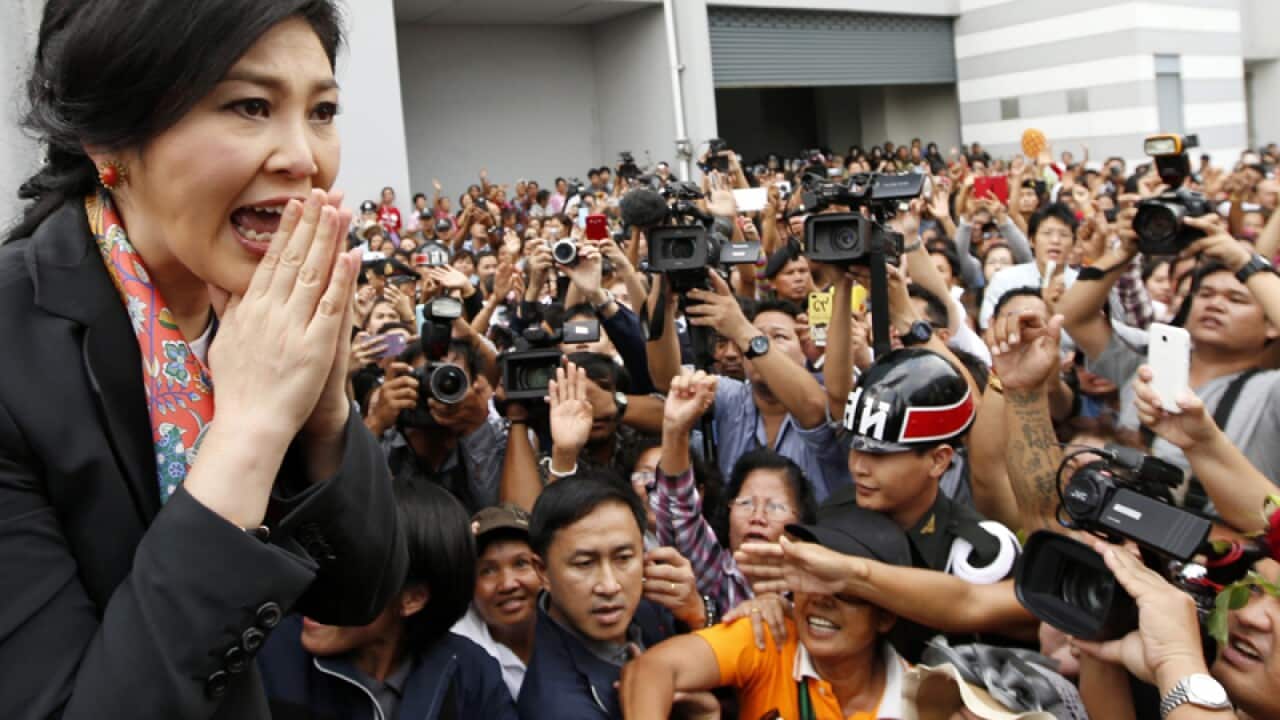 Thai caretaker prime minister Yingluck Shinawatra greets supporters