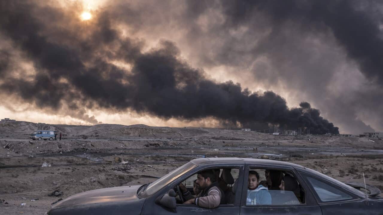 "Iraq's Battle To Reclaim Its Cities" shows a family flees the fighting in Mosul, Iraq's second-largest city, as oil fields burned in Qayyara, Iraq.