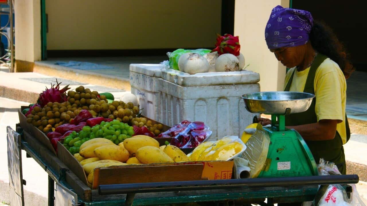 a woman selling fruit
