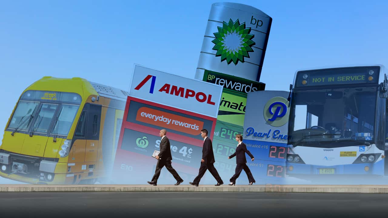 Commuters walk past buses, light rail and petrol station signs as Australians rethink travel costs.