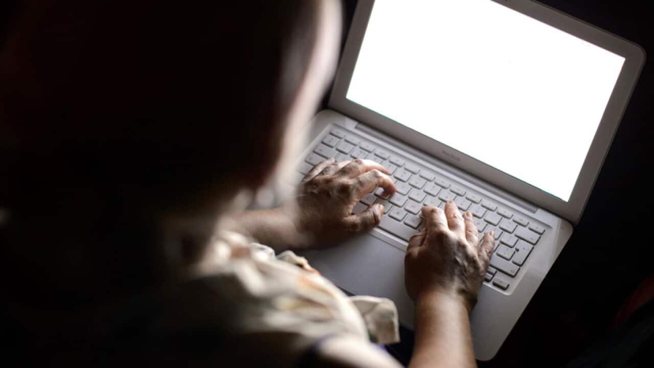 A person using a laptop computer.