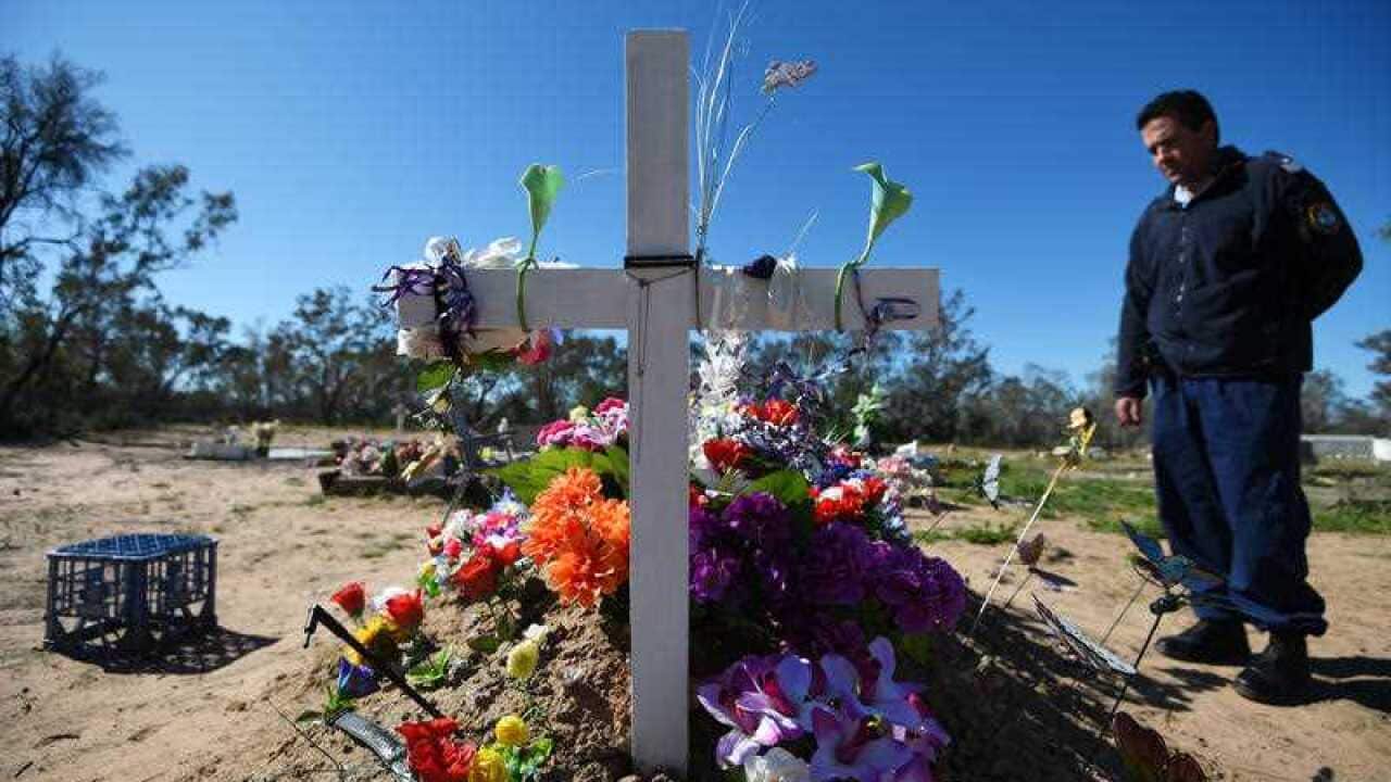Brewarrina based Leading Senior Constable Dave Wheatley at the grave of domestic violence victim Maleeta Hart in the in the NSW outback town of Weilmoringle, 100km north of Brewarrina,