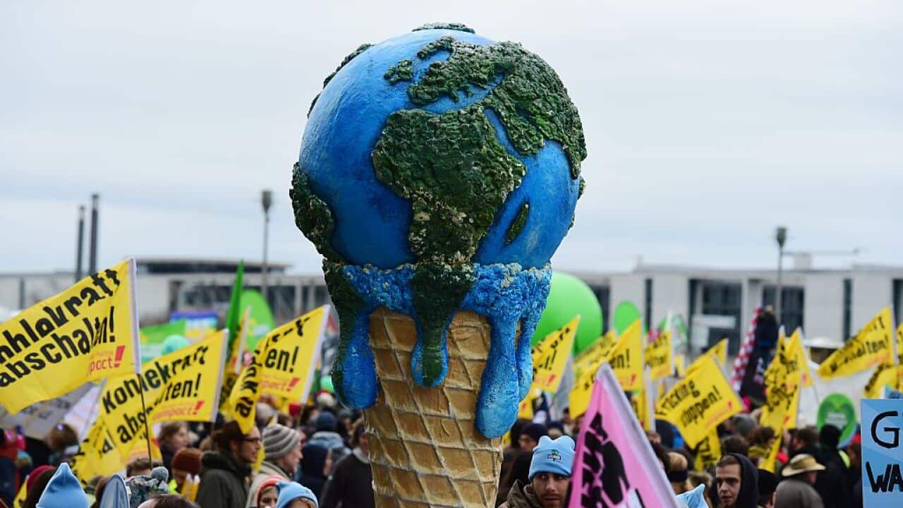 A melting planet in an ice cone is held up during the "Global Climate March" that is organised by environmental NGOs on November 29, 2015