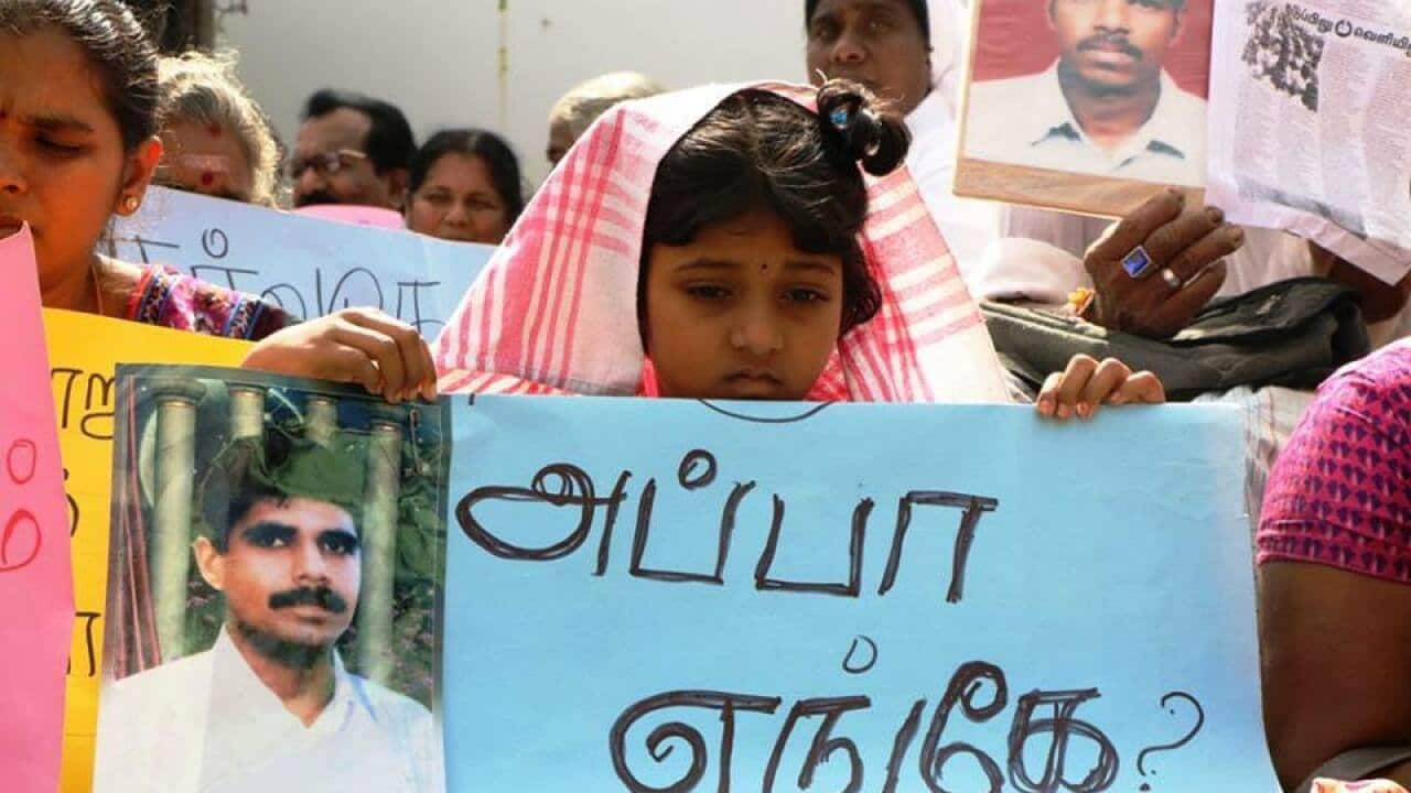 Children and women hold portraits of missing loved ones, during a protest demanding the Sri Lankan government investigate enforced disappearances.