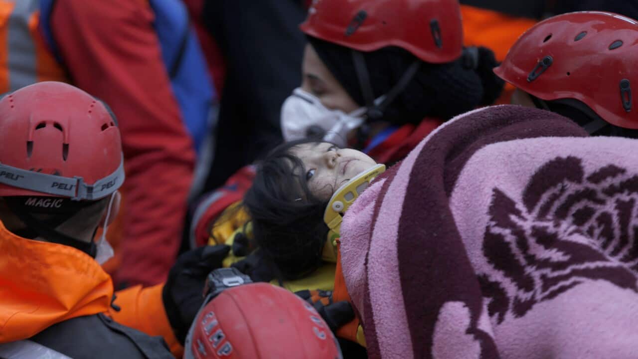 Rescuers carry an injured 5 years old girl Havva Tekgoz, on a stretcher from the site of a collapsed building in Kartal district of Istanbul.