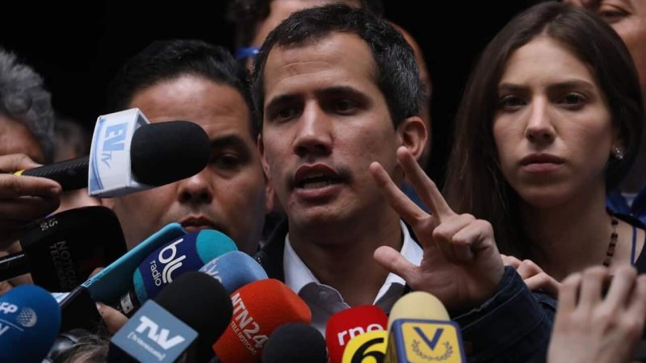 The President of the National Assembly of Venezuela Juan Guaido (C).