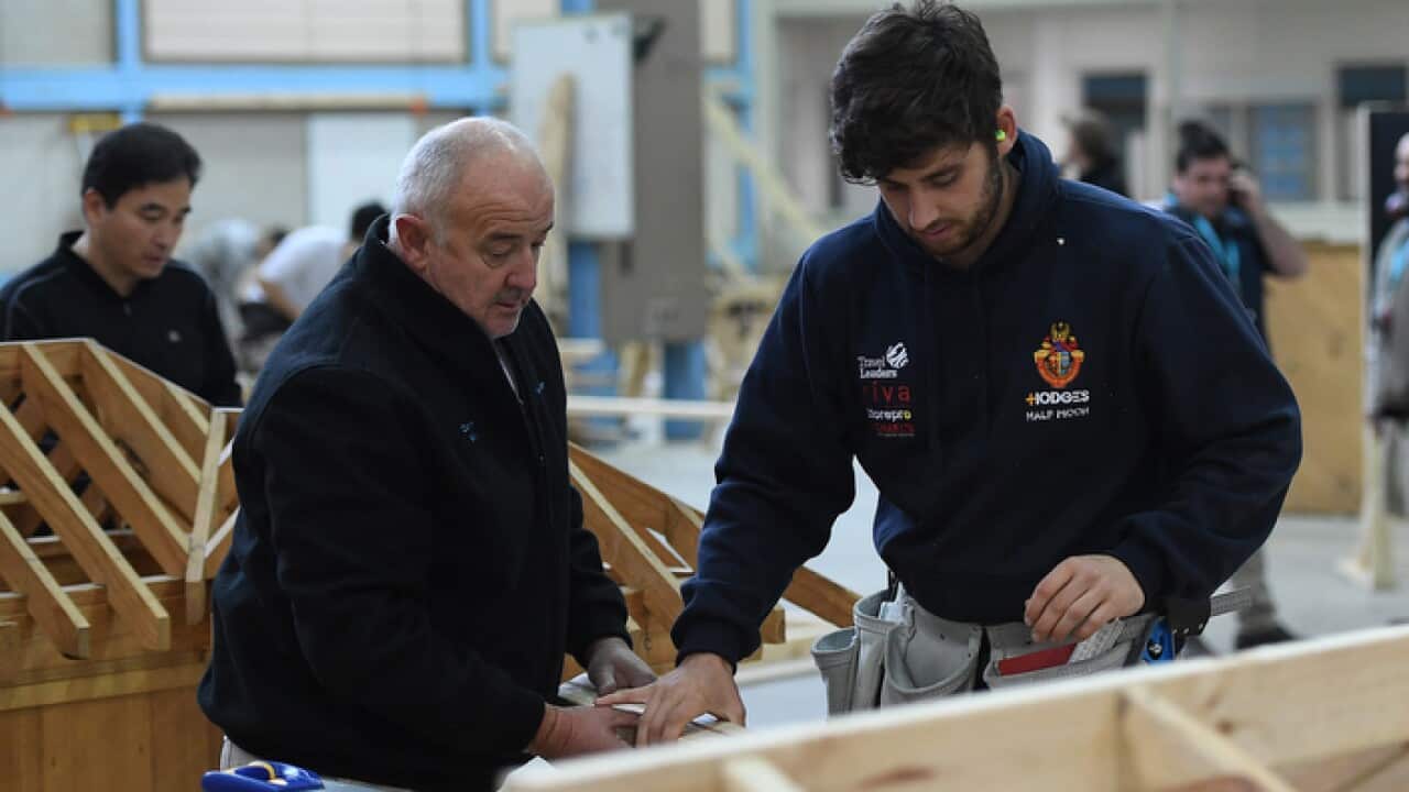 A master and apprentice carpenter are seen at Holmesglen TAFE Chadstone campus in Melbourne, Monday, May 15, 2017. (AAP Image/Julian Smith) NO ARCHIVING
