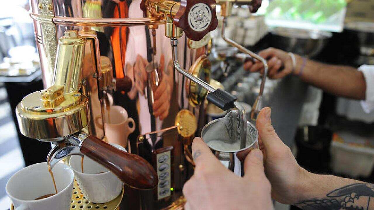 A barista makes coffee in the Lavazza marquee in the Birdcage at Flemington racecourse in Melbourne