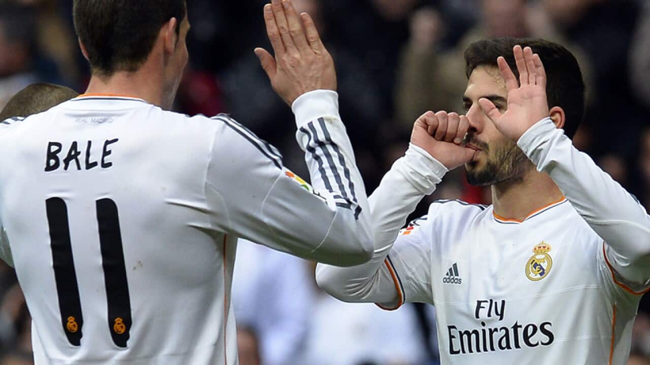 Real Madrid's Isco (R) celebrates after scoring