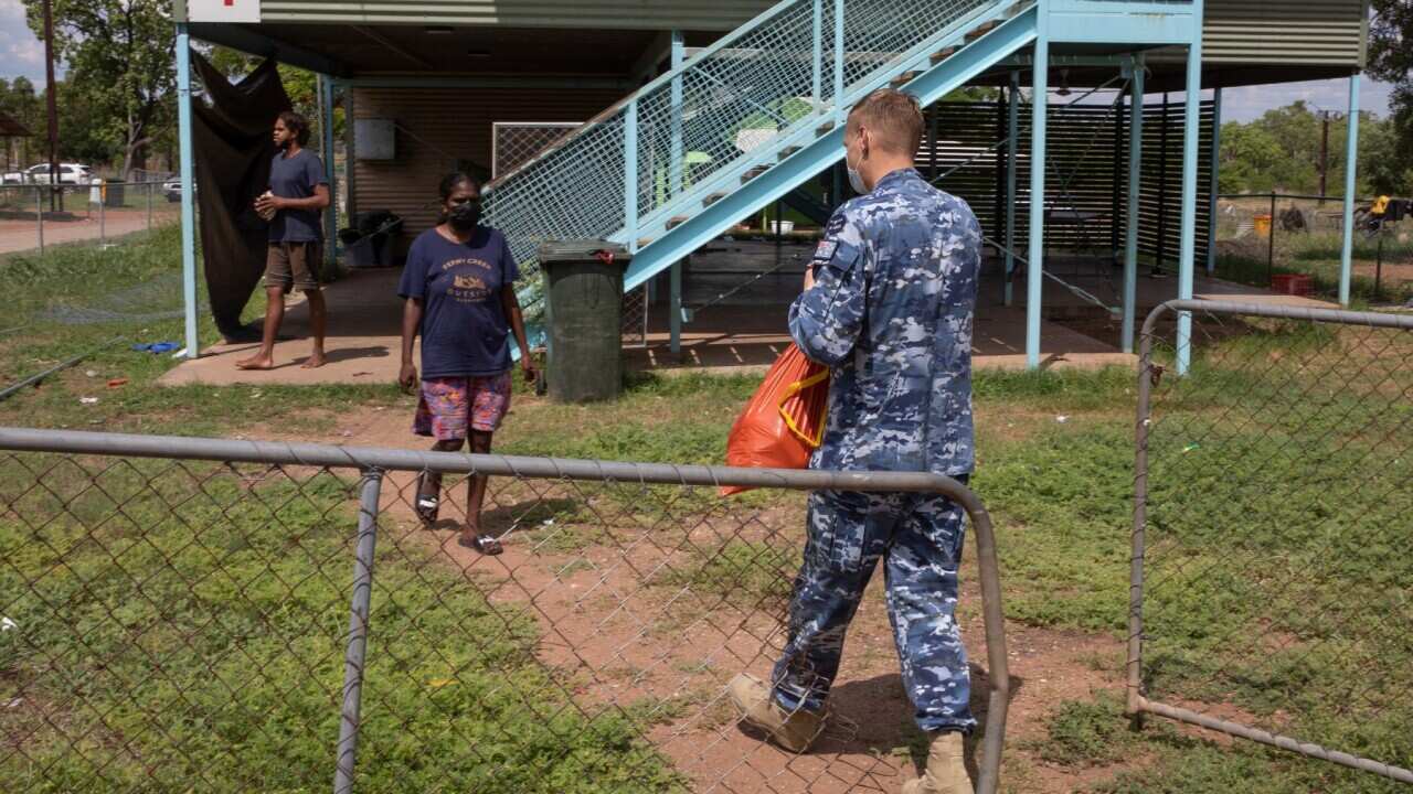 A supplied image obtained on Saturday, November 27, 2021, shows Flight Lieutenant Mark Tomlinson from Joint Task Force 629, deployed on Operation COVID Assist, delivering bags of food to the families at the Rockhole community in the Northern Territory.