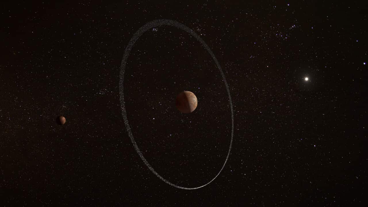 An artist's impression of dwarf planet Quaoar in space, with a planetary ring around it with orbiting stars