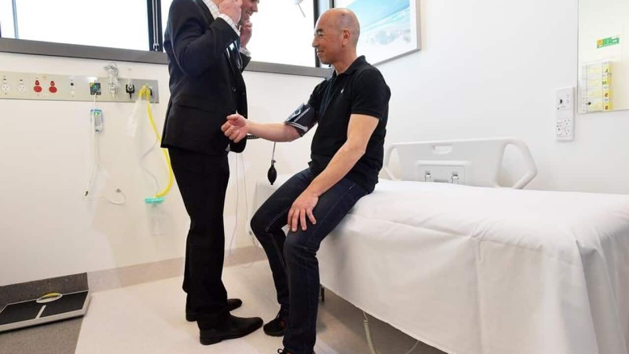 Dr Philip Clayton consults with first outpatient Paul Panos
