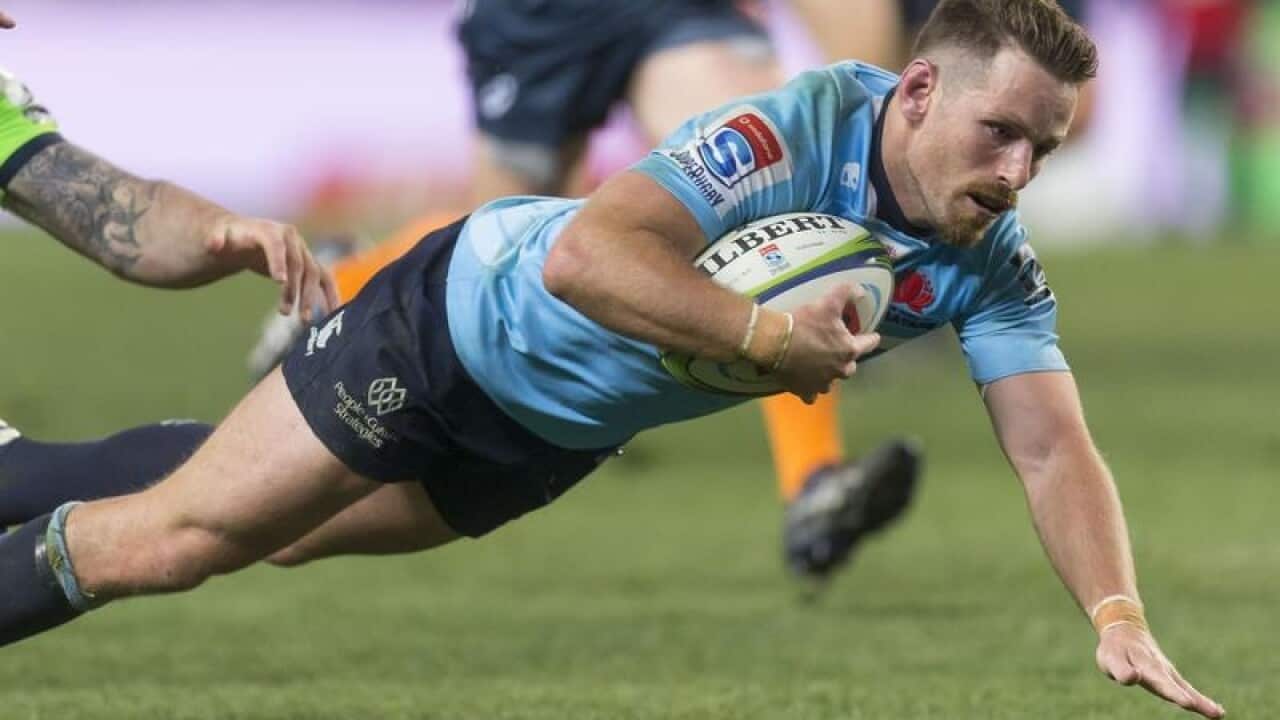 Acting NSW Waratahs captain Bernard Foley scores a try