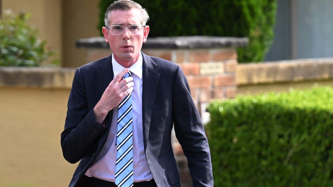 NSW Premier Dominic Perrottet walks into a press conference