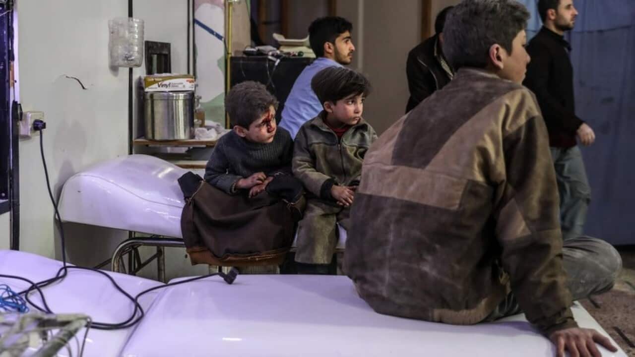 Injured children with their brothers at a hospital in Syria