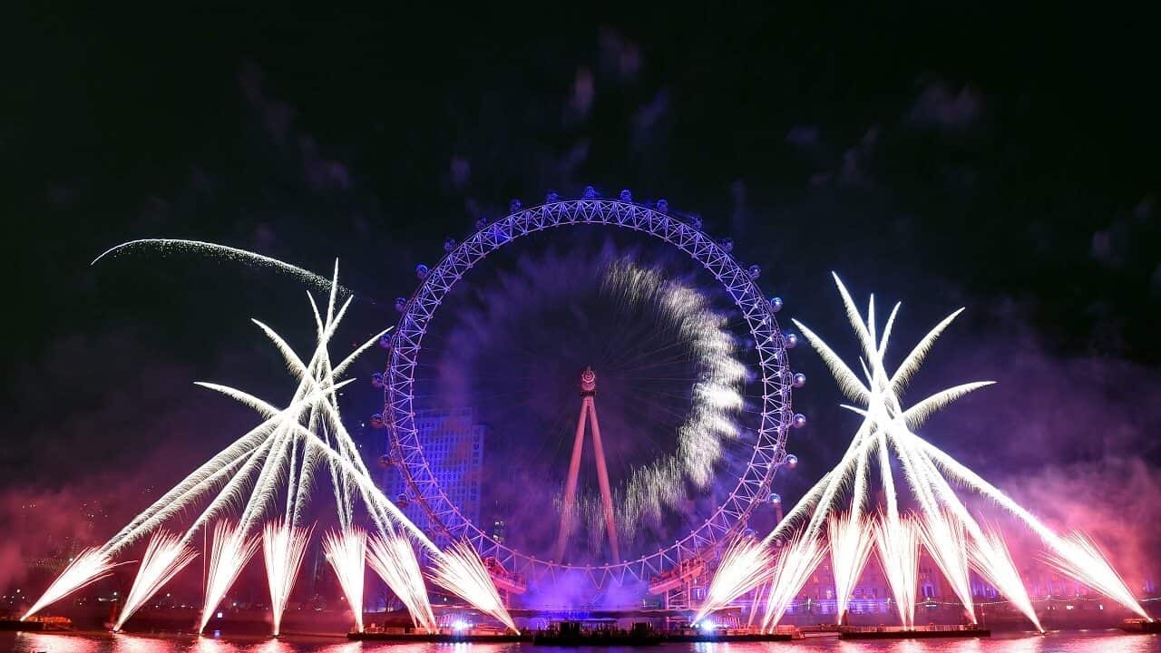Fireworks explode over the iconic London Eye marking the beginning of the New Year in central London.
