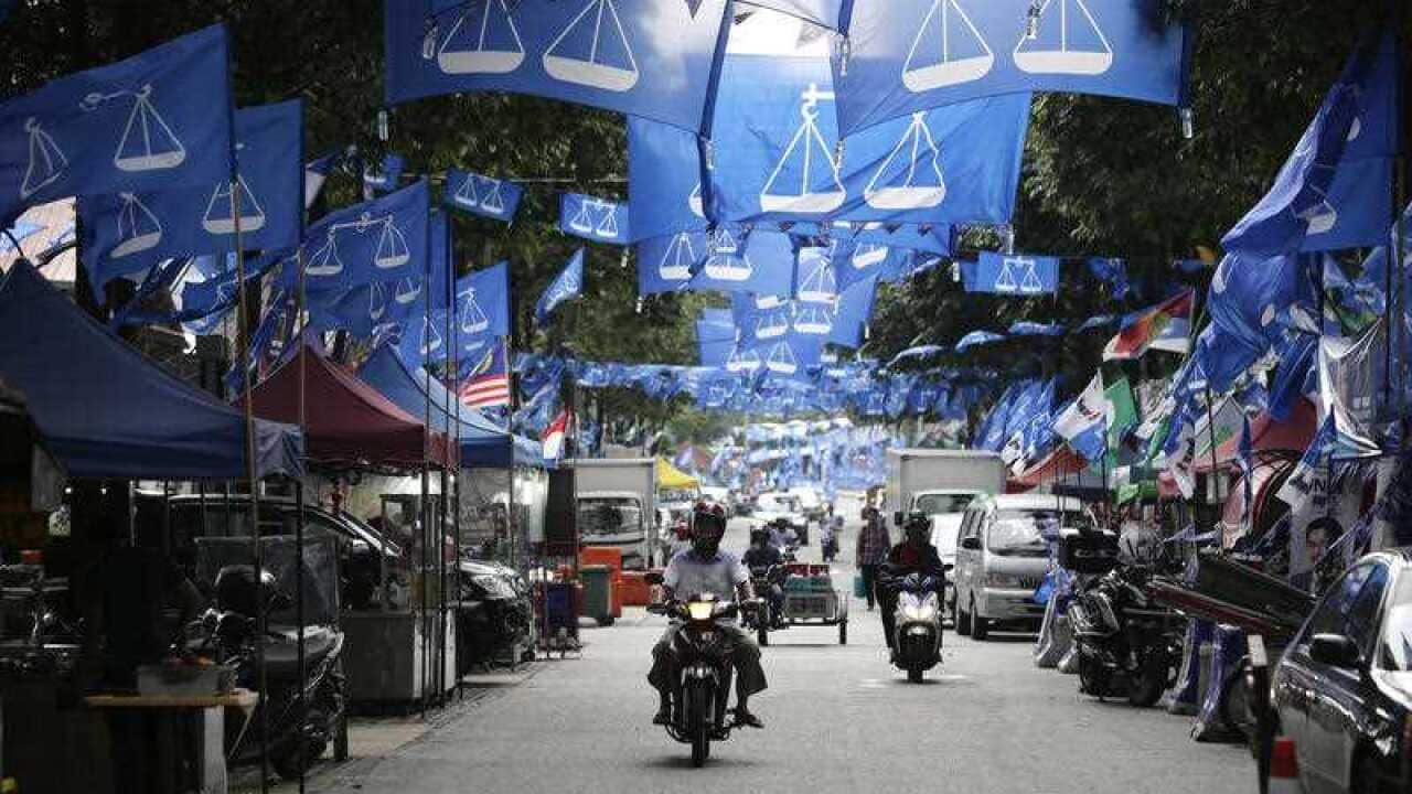 Flags from different political parties are hung along a street in Kuala Lumpur, Malaysia, Monday May 7, 2018.
