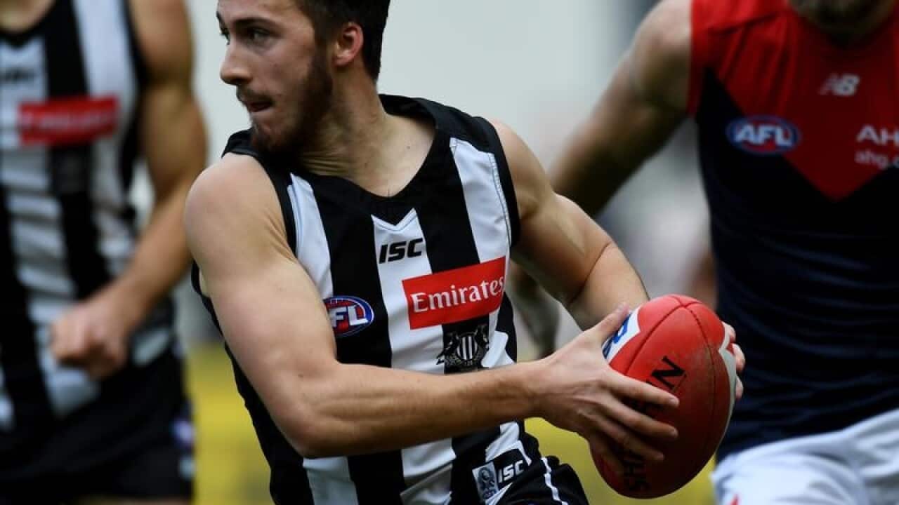 Tom Phillips of the Magpies in action against Melbourne Demons.
