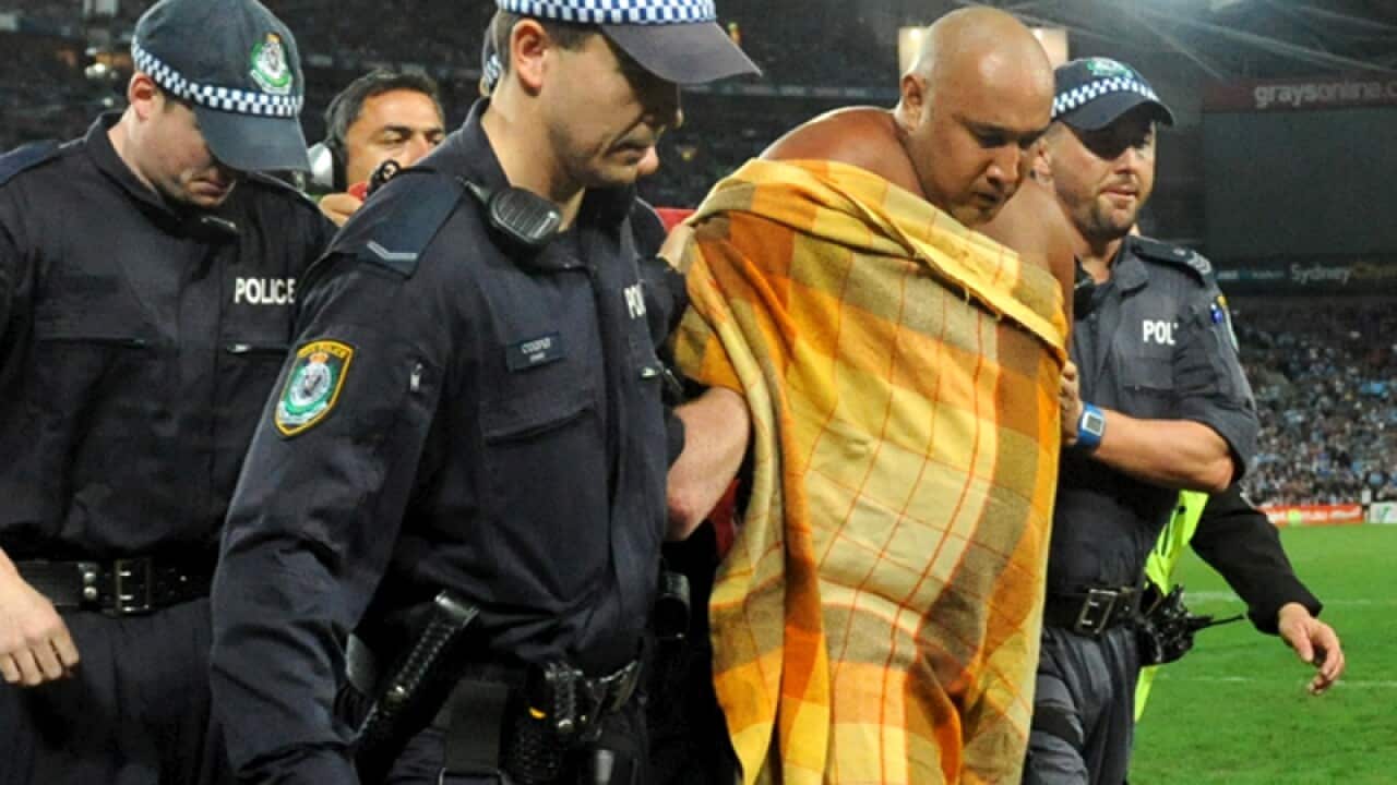 Wati Holmwood is escorted off the field during State of Origin III