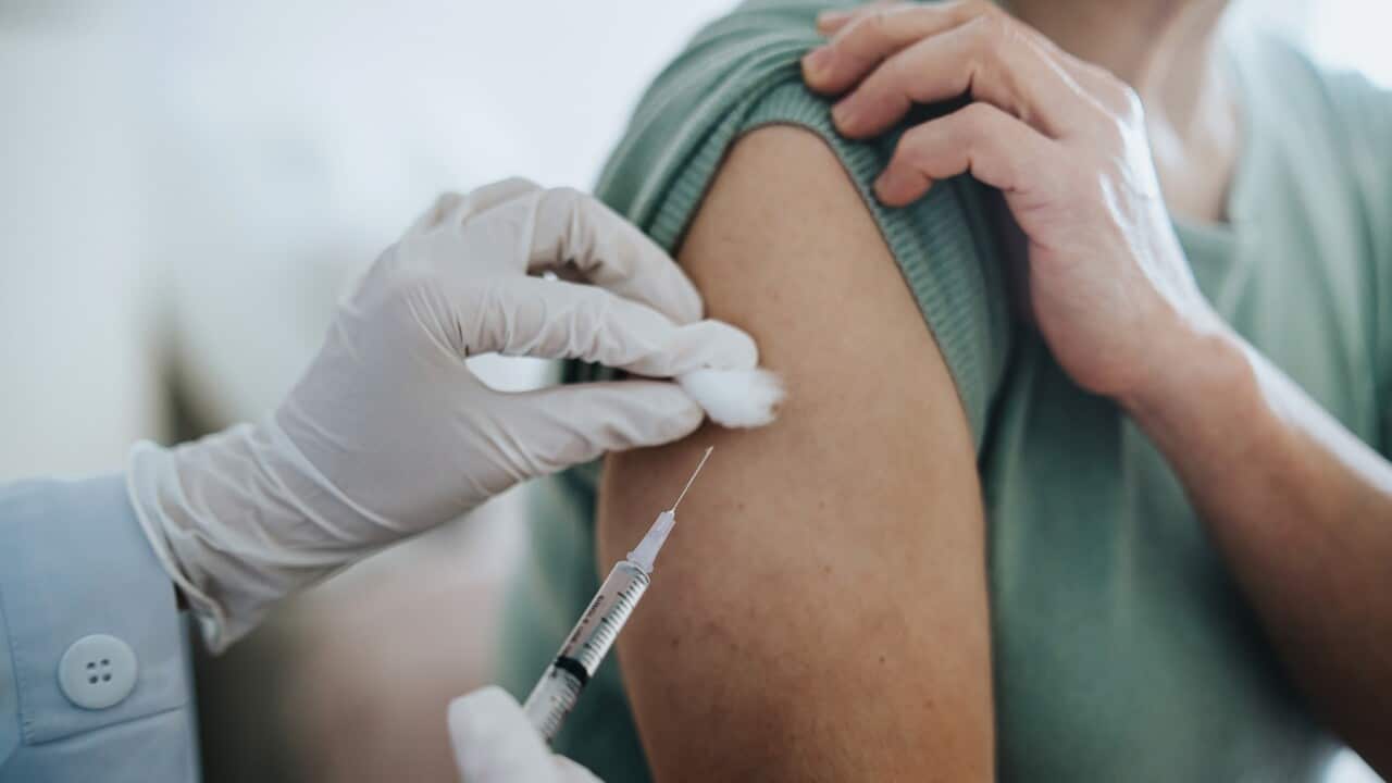 Woman getting vaccine in arm