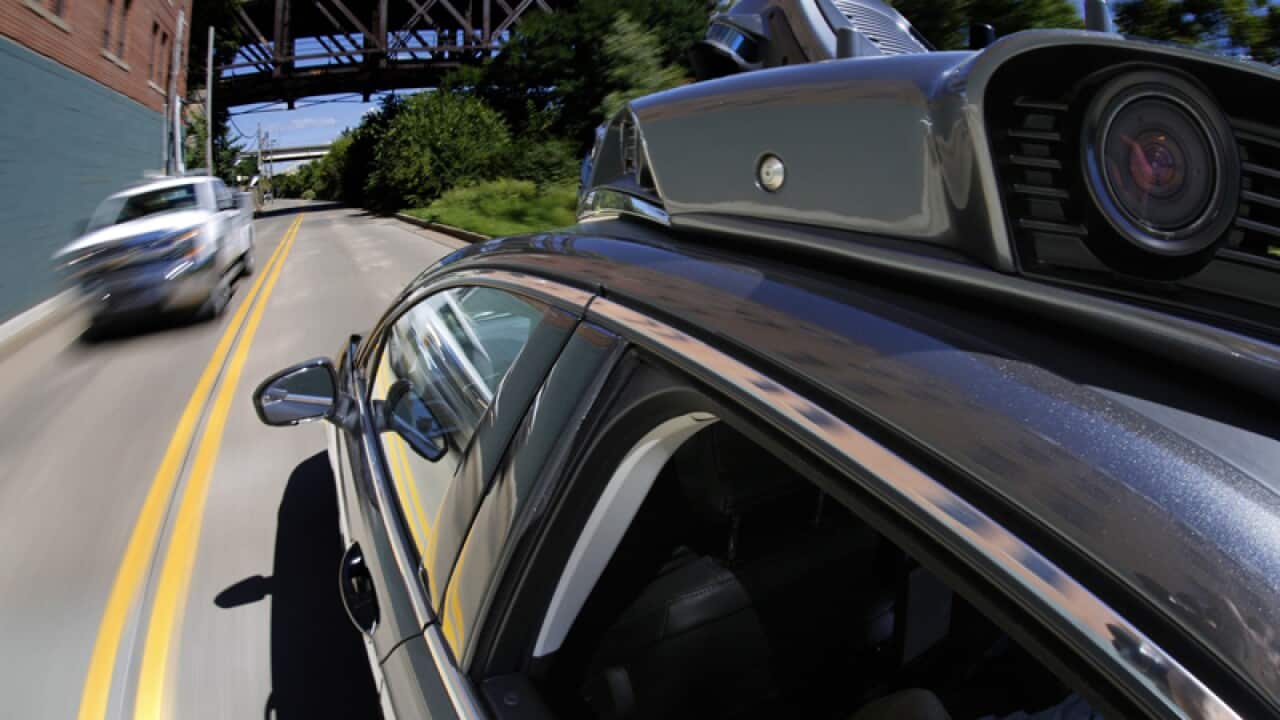 A self-driving Uber drives in Pittsburgh