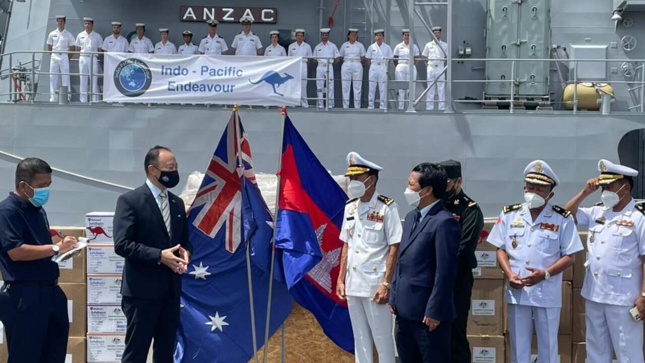Australian ambassador Pablo Kang, second from left, hands over COVID-related equipment to Cambodian authorities in the southern port of Sihanoukville after HMAS Anzac sailed into port to commemorate the 30th anniversary of the Paris Peace Agreements.