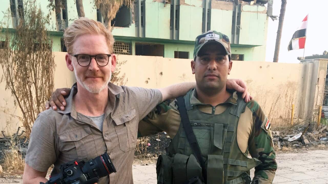 Reporter Amos Roberts with an Iraqi solder in Mosul.