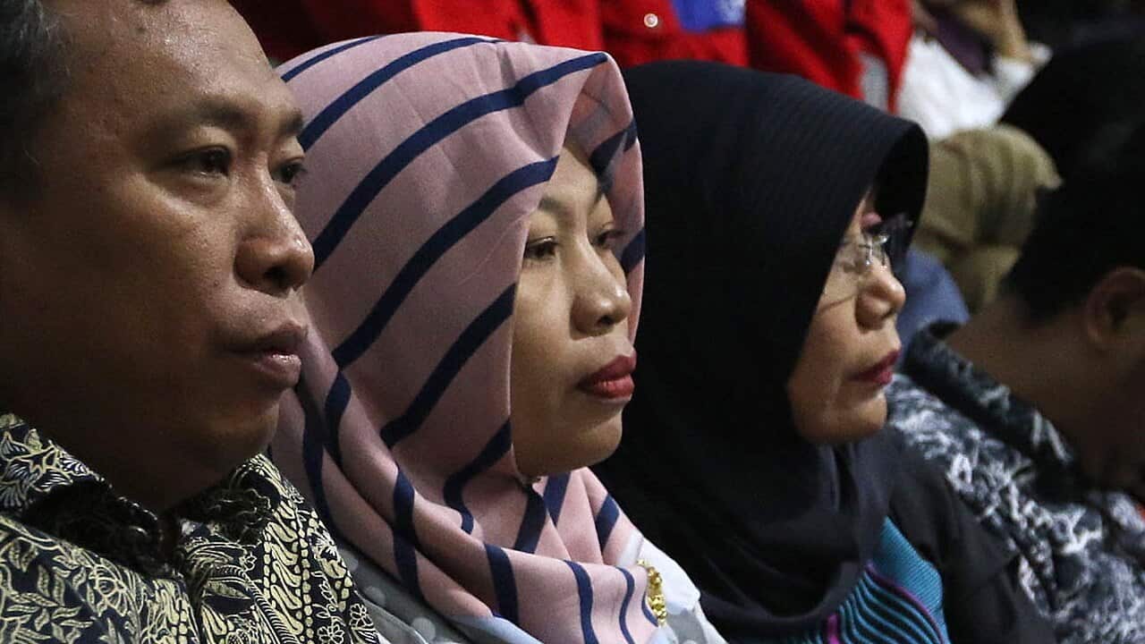 Indonesia's parliament approved an amnesty for Baiq Nuril Maknun (c) after the Supreme Court had rejected her appeal.