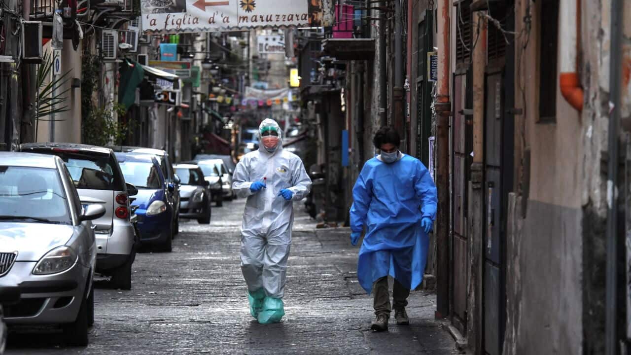 Doctors wear protective clothing as they carry out checks on citizens in Naples, Italy