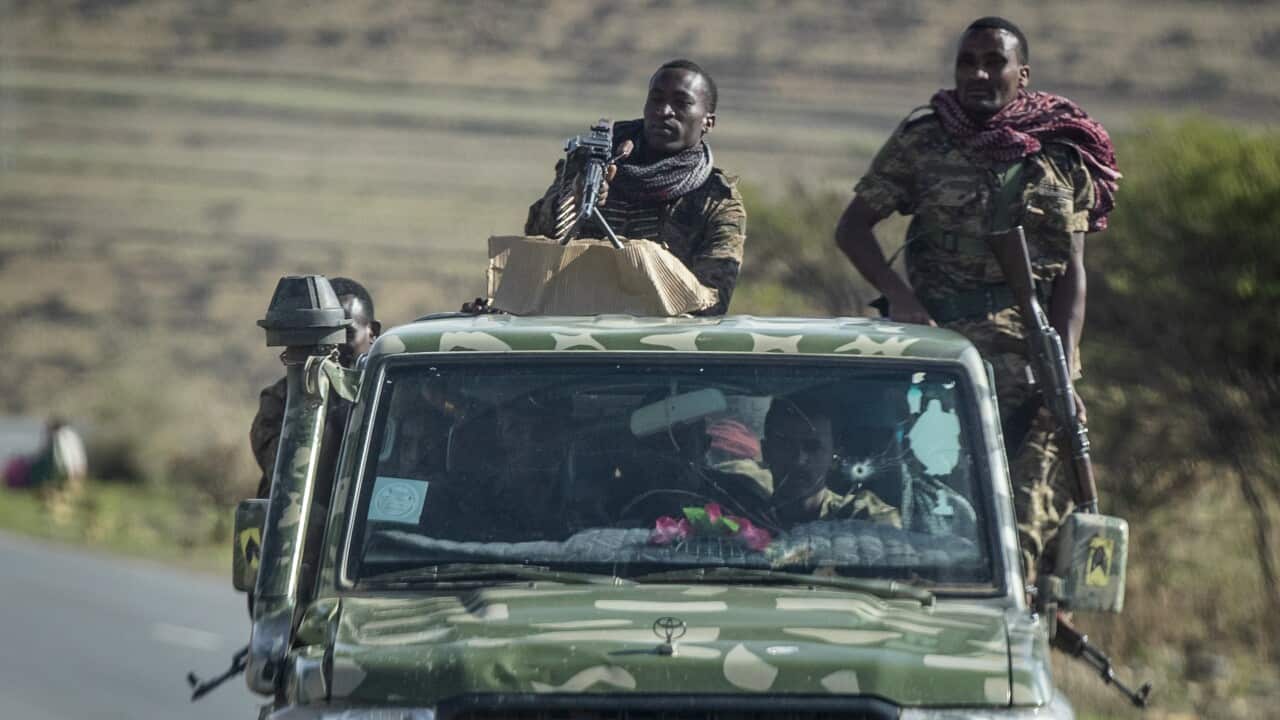 Ethiopian government soldiers ride in the back of a truck on a road near Agula, north of Mekele, in the Tigray region of northern Ethiopia. (AAP)