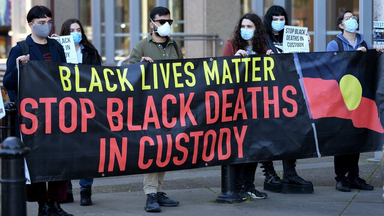 Black Lives Matters supporters are seen during a press conference at the Supreme Court of NSW in Sydney.