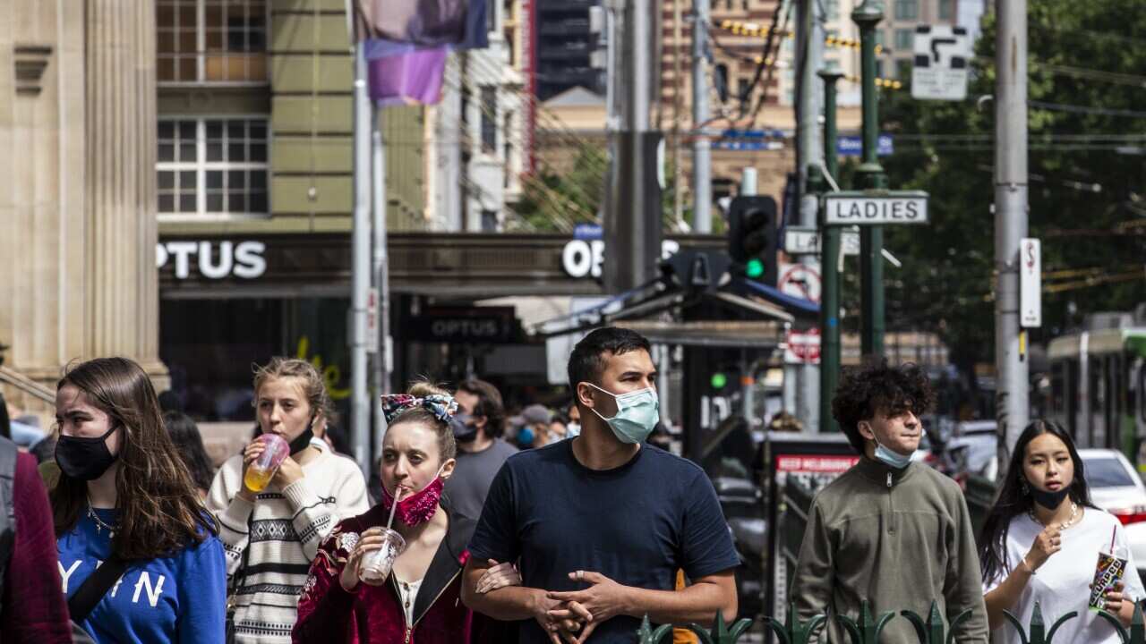 People wearing face masks are seen walking on Elizabeth Street, Melbourne, 7 November 2020.