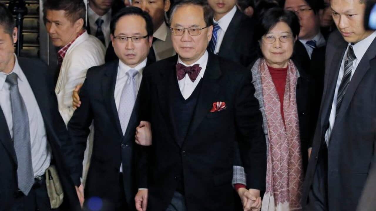 Donald Tsang, center, former leader of Hong Kong, and his wife Selina walk out of the High Court after being granted bail following his conviction