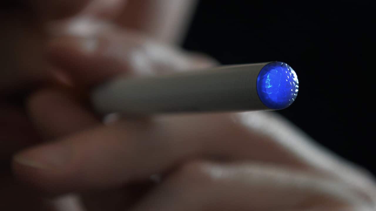 a person smoking an e-cigarette