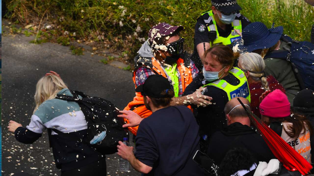 Victoria Police clash with protesters during a rally in Melbourne, Saturday 18 September.