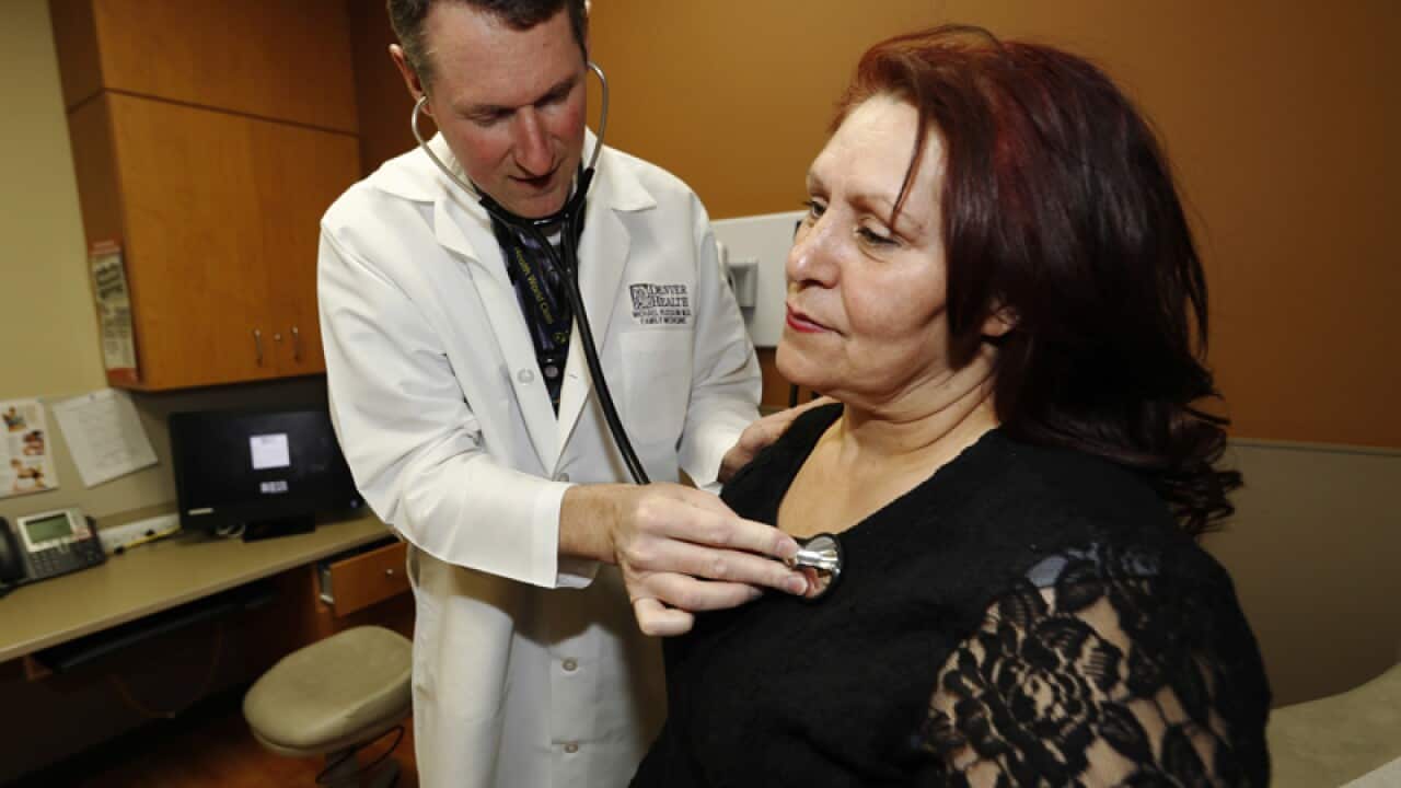 A doctor examines a patient in Denver