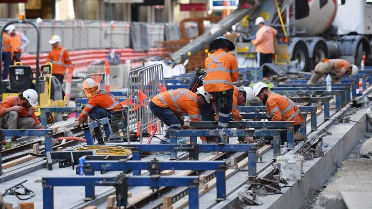 Workers are seen on the George St, Sydney CBD Light Rail Project.