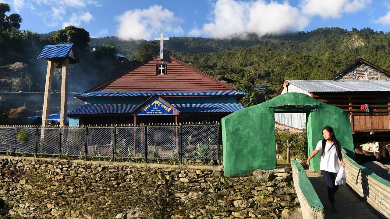 Nepali girl walks from a church in Dhading, Nepal.