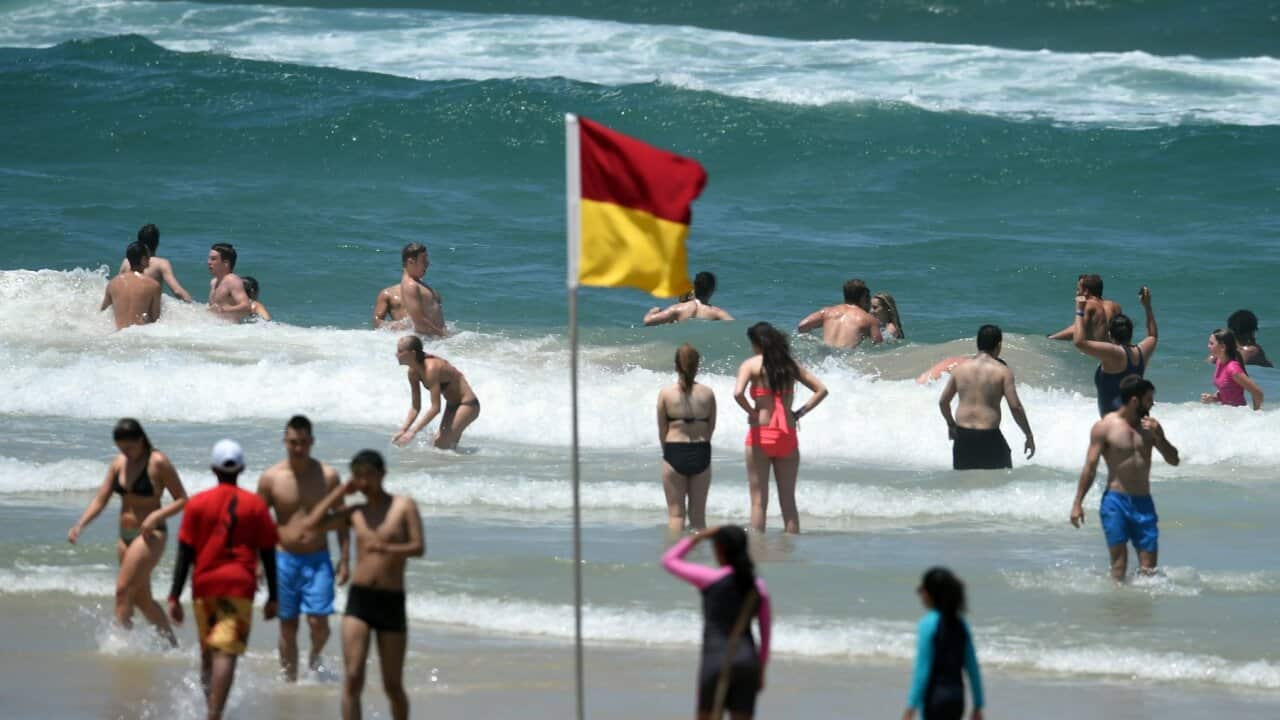 Beachgoers cool down at Surfers Paradise on the Gold Coast, Friday, Dec. 2, 2016