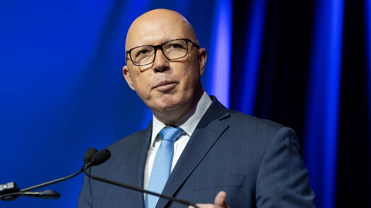 A bald man in a suit and glasses (Peter Dutton) speaks at a lectern.
