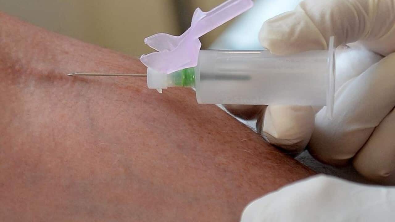 A nurse collecting blood from a patient.