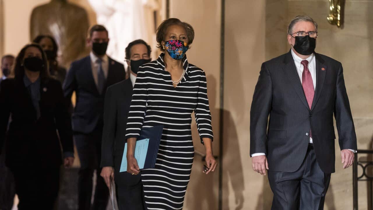 Clerk of the House of Representatives Cheryl Johnson carries the article of impeachment through the US Capitol in Washington, DC, USA, 25 January 2021.