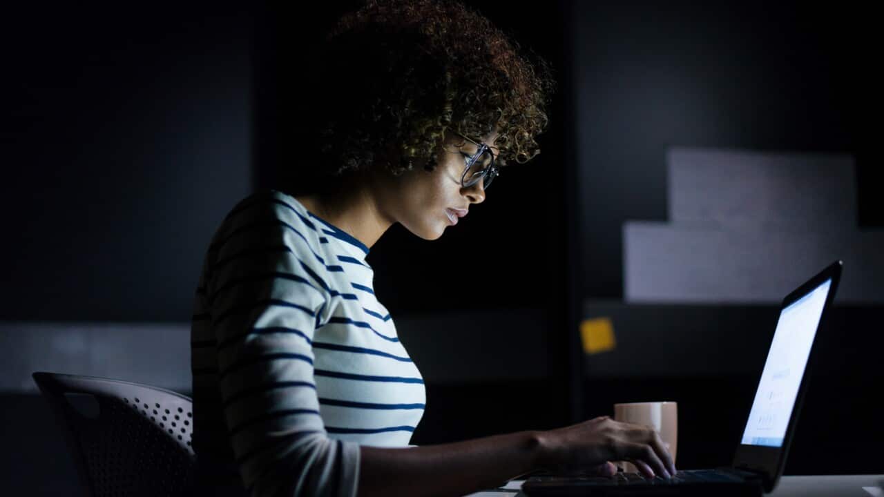 Concentrated businesswoman working late hours with her laptop