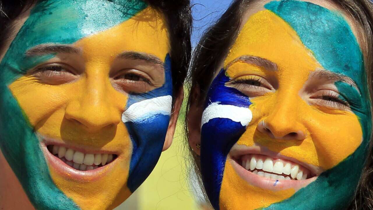 Brazilian supporters have their faces painted in national colours