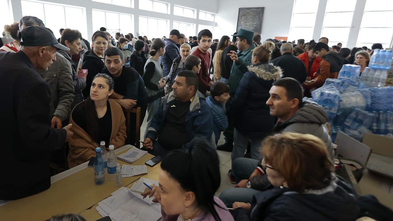 Ethnic Armenians who fled Nagorno-Karabakh line up to receive humanitarian aid
