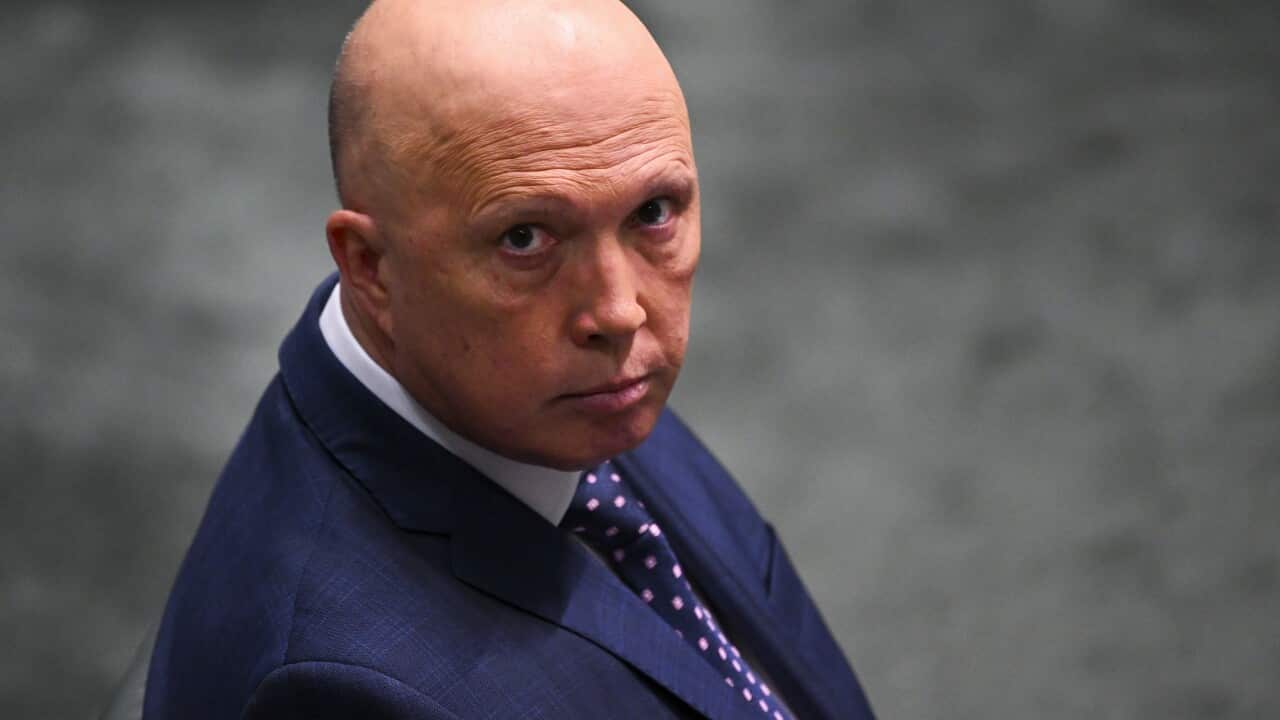 Peter Dutton wearing a suit and tie in Parliament House