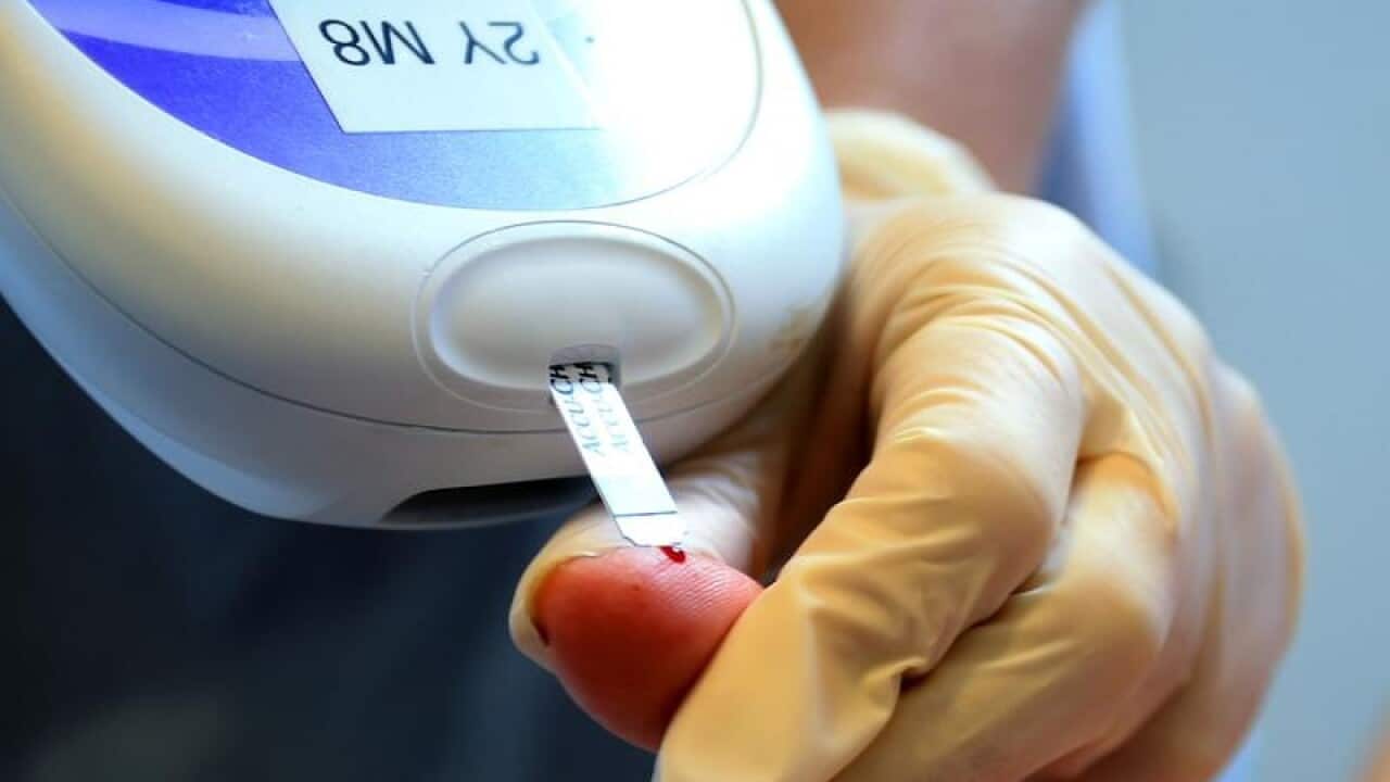 A file image of a nurse giving a patient a diabetes test