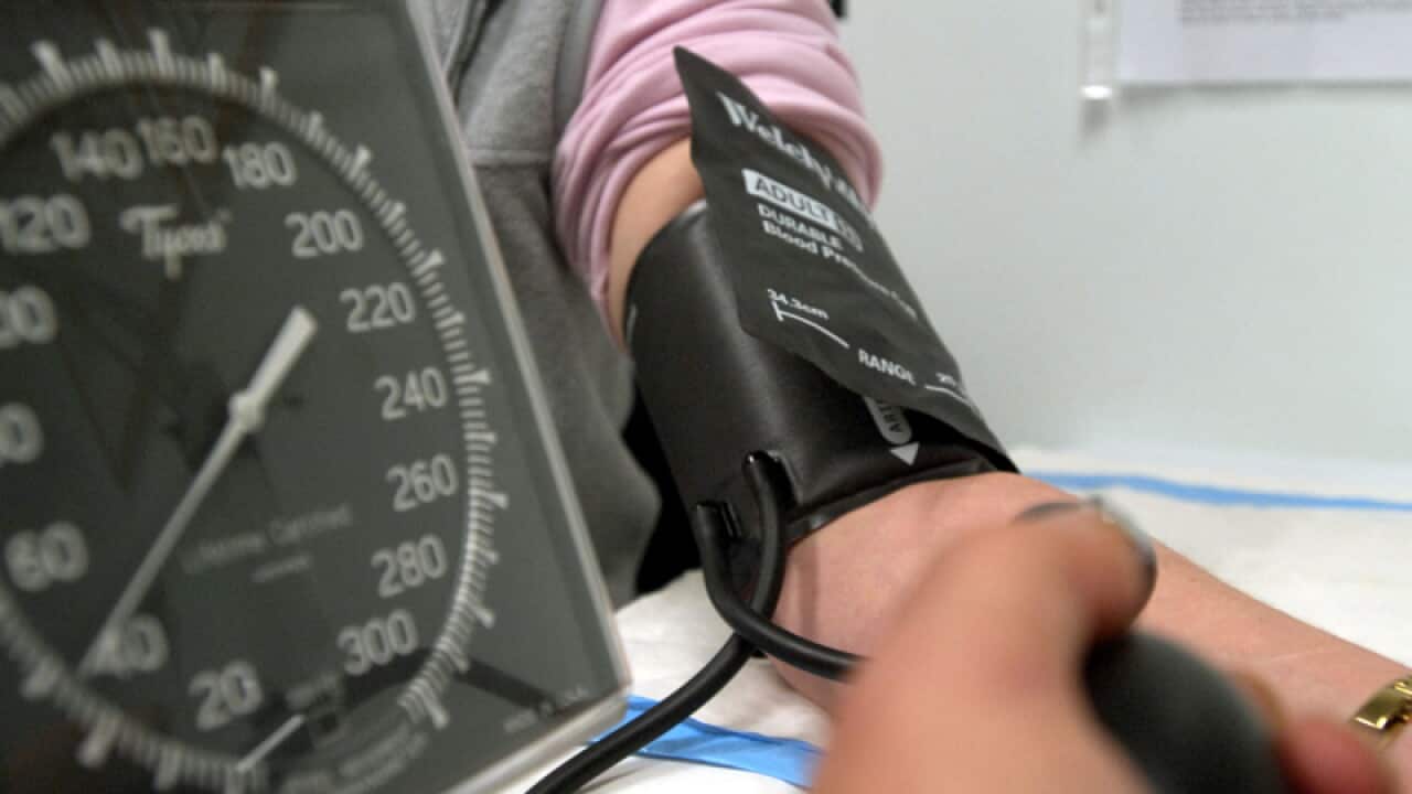 A patient has her blood pressure checked